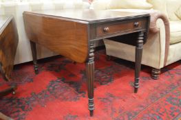 A 19th century mahogany pembroke table with reeded legs.
