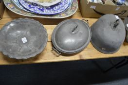 A pewter dish and similar items.