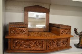 An Eastern carved hardwood dressing table mirror with storage boxes and drawers.