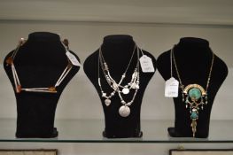 Three stylish silver necklaces.