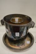 A plated champagne bucket with rams horn handles and two other items.