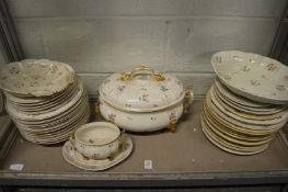 A Crown Derby part dinner service decorated with gilt blue and red flowers.
