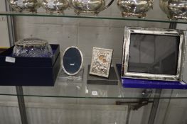 Silver plated photograph frames, cut glass rose bowl with silver rim and a modern silver icon.