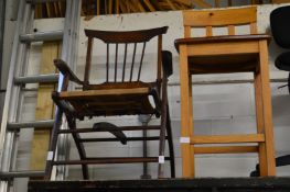 A folding chair and a pine bar stool.