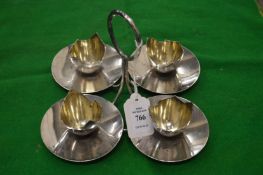 A stylish four piece egg cruet and stand.