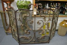 An ornate folding fire screen.