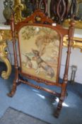 A good Victorian walnut firescreen, the central embroidered panel depicting two dogs.