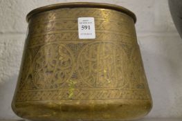 An Islamic engraved brass bowl.