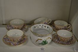 A small Herend bowl together with six cups with five saucers each decorated in gilt blue and iron