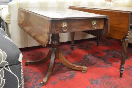 A Regency mahogany and rosewood banded pedestal pembroke table.