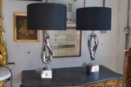A pair of stylish chrome plated table lamps.