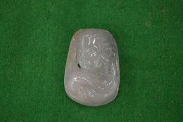 A Chinese carved jade amulet.