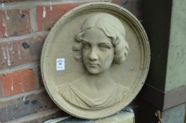 A composite relief cast art nouveau style circular plaque depicting the bust of a young lady.