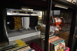 An electric shoe polishing machine, bench grinder and a wall light.