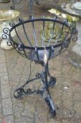 A wrought iron plant stand.