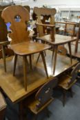 An unusual Swiss walnut dining room suite comprising: drawleaf table, ten chairs, two with arms,