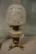 An ornate brass and cut glass oil lamp.