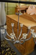 A stylish chrome plated eight branch chandelier.