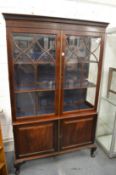 A mahogany cupboard bookcase.