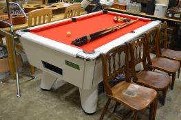 A Supreme pool table with accessories.