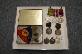 A small group of medals and awards for R Benchley to include a regular army long service medal,