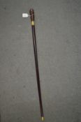 A walking stick, the handle modelled as a phrenology head.