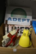 An old desk fan, desk lamp and two enamel signs.