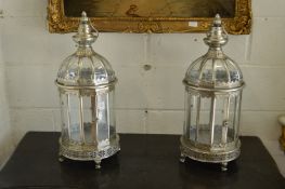A pair of silvered metal lanterns.