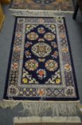 A Chinese rug 153cm x 92cm.