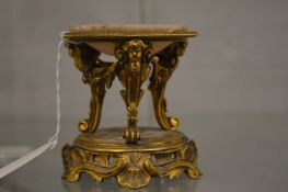 An ormolu miniature brasier or oil burner with associated alabaster dish.