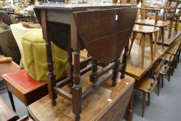 An oak dropleaf gateleg dining table.