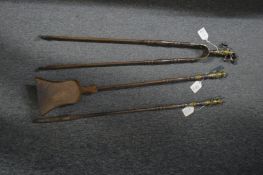 A brass and steel three piece fireside companion set.