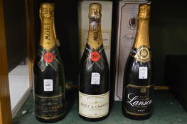 Three bottles of Moet and Chandon champagne and three other bottles of champagne.