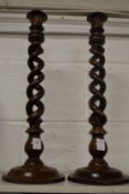 A pair of wooden open barley twist candle sticks.