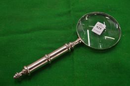 A decorative magnifying glass.
