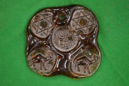 An unusual large moulded amber colour glass pendant.