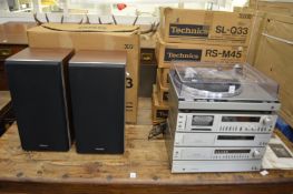 A Technics stacking hi-fi system complete with pair of speakers and storage unit.