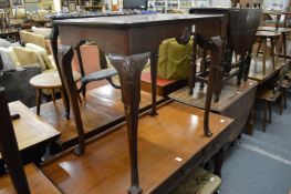 A George III style mahogany 'silver' table with shell carved frieze on carved cabriole legs with