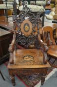 An unusual, rare 'Black Forest' carved and inlaid musical armchair.