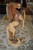 An impressive large carved wood model of a rearing horse 120cm high.