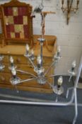 A stylish chrome plated nine branch chandelier.