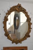 A gilt plaster framed mirror.