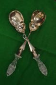 A pair of silver plated salad servers with cut glass handles.
