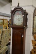 A 19th century mahogany longcase clock with eight day movement, the painted arched dial depicting