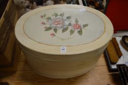 A painted oval wooden box.