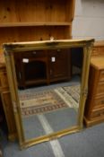 A gilt framed mirror.