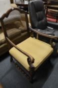 A walnut framed open armchair with canework back and seat with upholstered cushion.