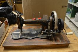 A sewing machine and quantity of unframed tapestries.