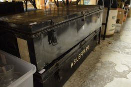 Two large black japanned steel trunks.