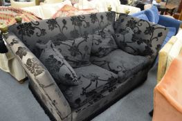 A large Knoll style two seater settee upholstered in a black fabric with cut velour detail.